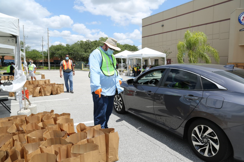 OCCC Sustainability Coordinator distributing PPE kits to small business owners